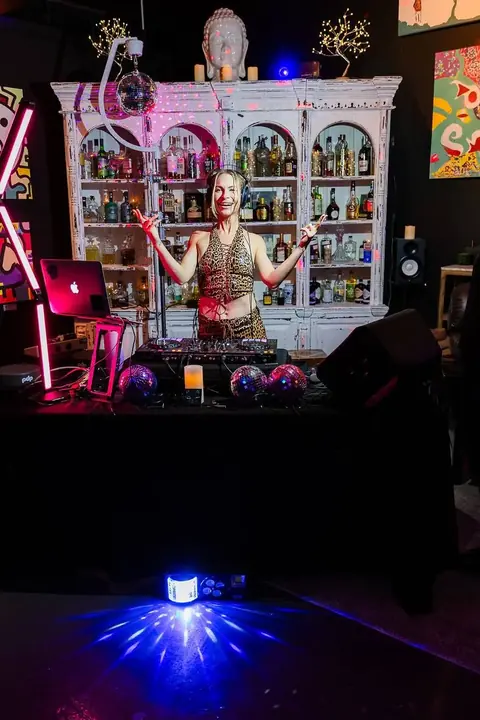 DJ Kat Walsh arms up at the decks